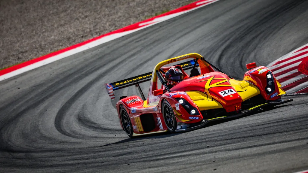 Radical sports car cornering at speed on track